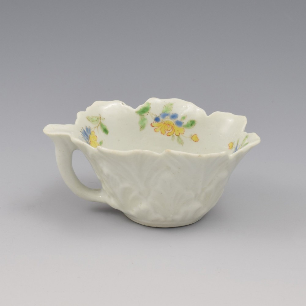 An eighteenth-century Dr Wall First Period Worcester soft-paste porcelain butter boat featuring hand-painted polychrome floral enamel sprigs and a leaf-moulded rim. View VI