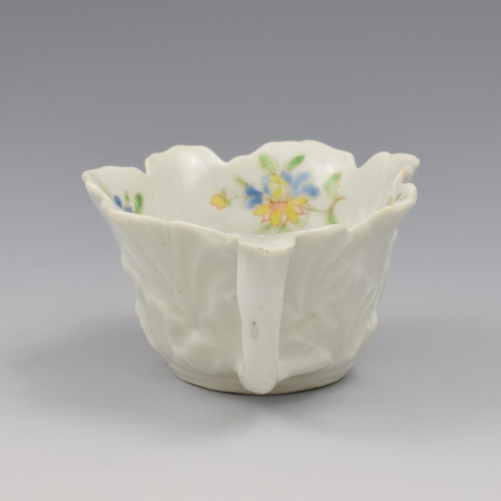 An eighteenth-century Dr Wall First Period Worcester soft-paste porcelain butter boat featuring hand-painted polychrome floral enamel sprigs and a leaf-moulded rim. View VIII