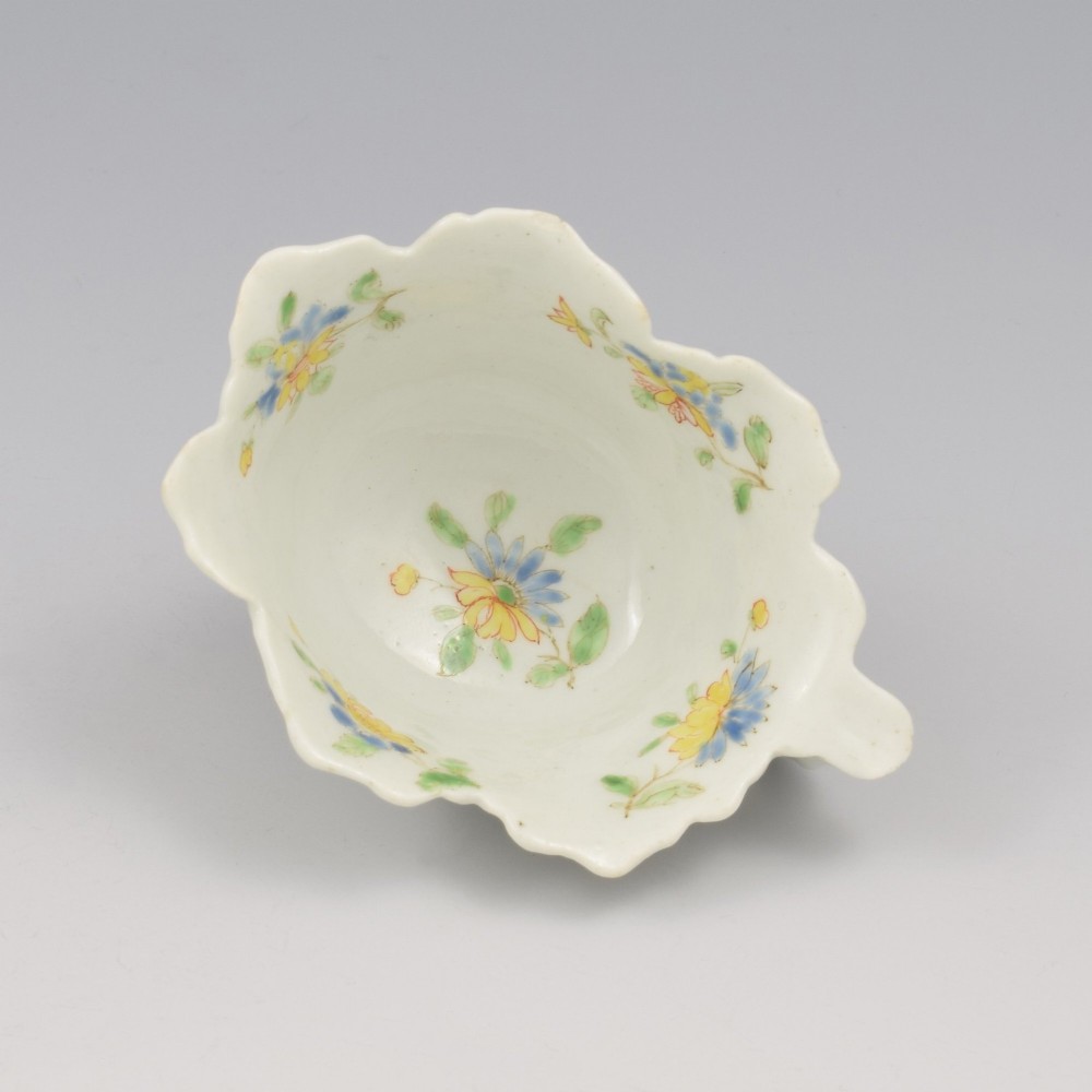 An eighteenth-century Dr Wall First Period Worcester soft-paste porcelain butter boat featuring hand-painted polychrome floral enamel sprigs and a leaf-moulded rim. View IX