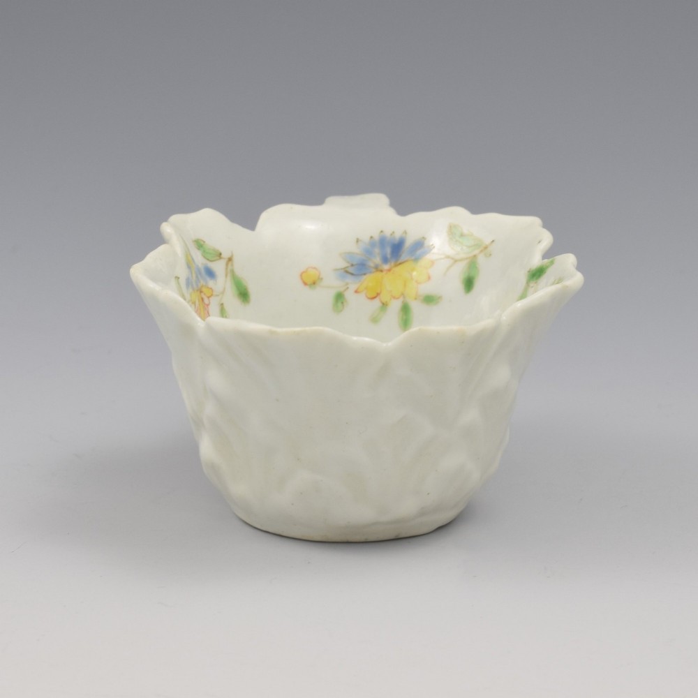 An eighteenth-century Dr Wall First Period Worcester soft-paste porcelain butter boat featuring hand-painted polychrome floral enamel sprigs and a leaf-moulded rim. View X