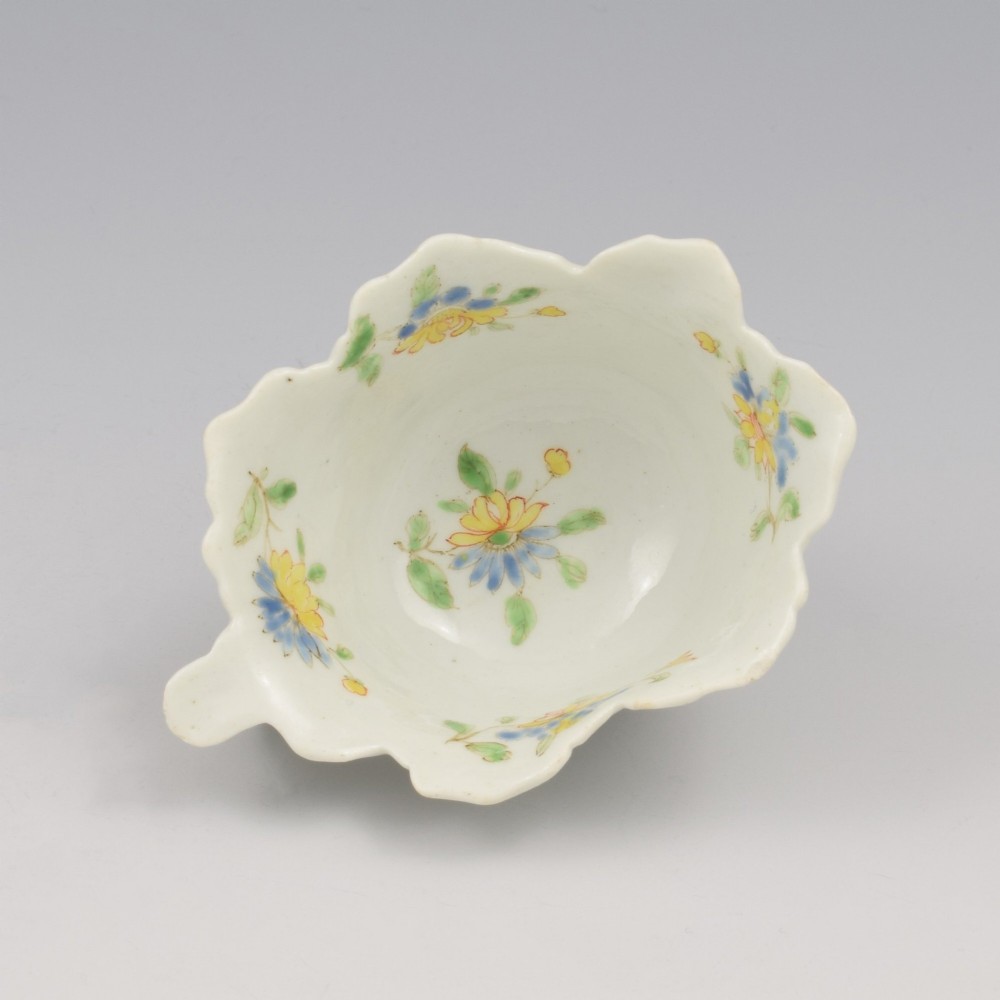 An eighteenth-century Dr Wall First Period Worcester soft-paste porcelain butter boat featuring hand-painted polychrome floral enamel sprigs and a leaf-moulded rim. View XI