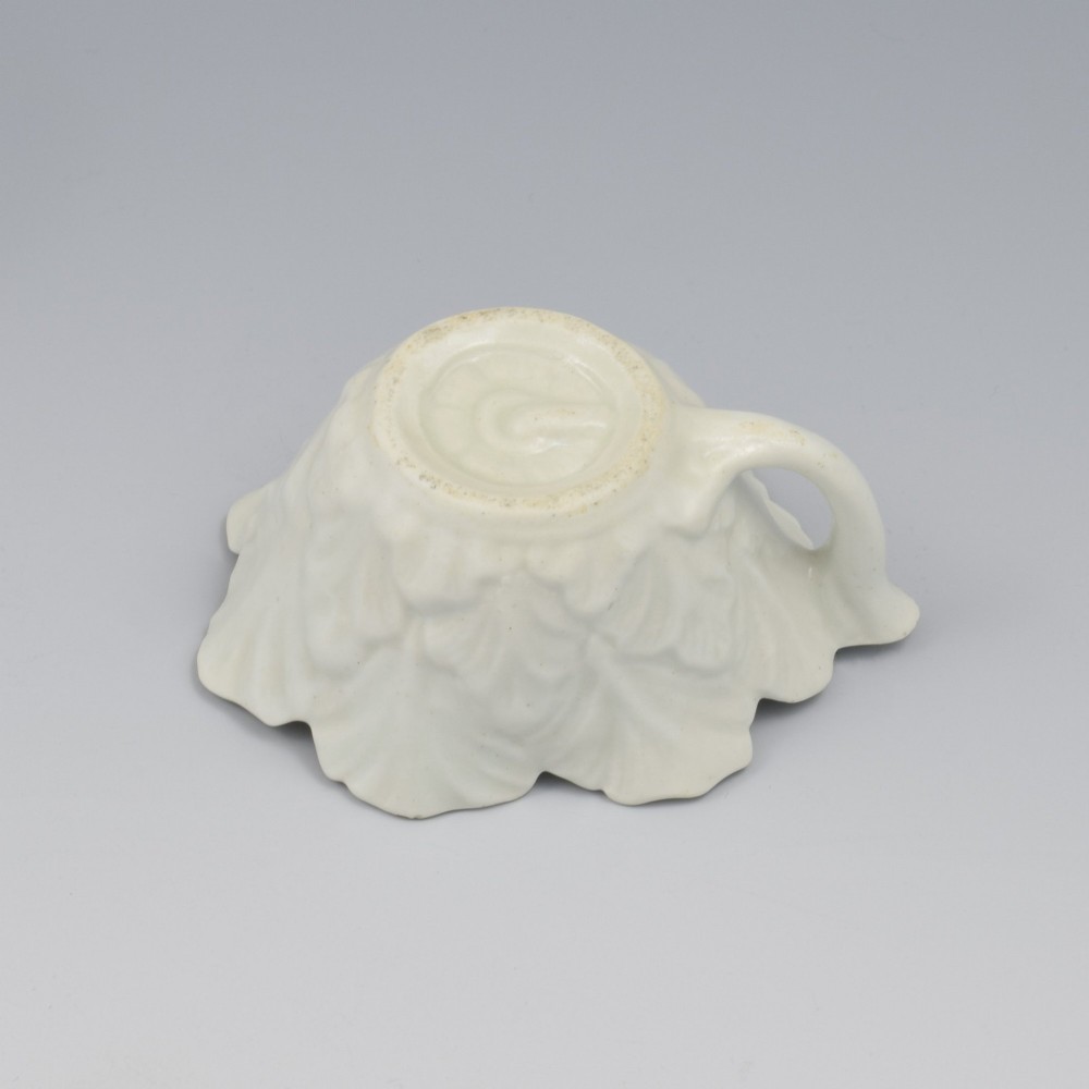 An eighteenth-century Dr Wall First Period Worcester soft-paste porcelain butter boat featuring hand-painted polychrome floral enamel sprigs and a leaf-moulded rim. View XII