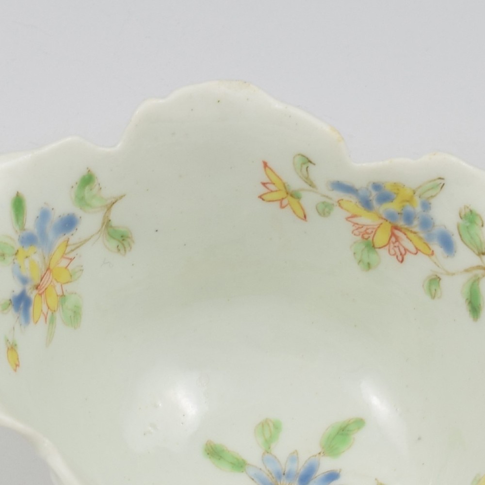 An eighteenth-century Dr Wall First Period Worcester soft-paste porcelain butter boat featuring hand-painted polychrome floral enamel sprigs and a leaf-moulded rim. View XIV