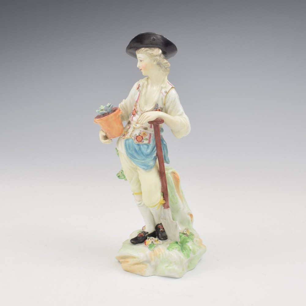An 18th-century Derby porcelain figurine depicting a gardener holding a flower pot and leaning on a spade. View VIII