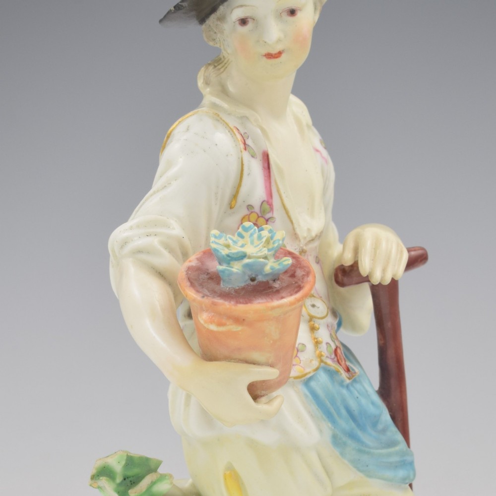 An 18th-century Derby porcelain figurine depicting a gardener holding a flower pot and leaning on a spade. View XII