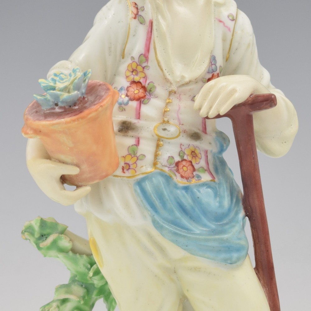 An 18th-century Derby porcelain figurine depicting a gardener holding a flower pot and leaning on a spade. View XIII