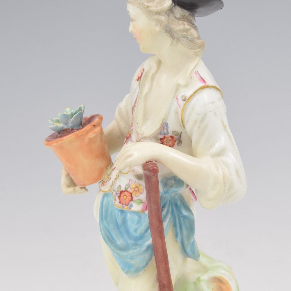 An 18th-century Derby porcelain figurine depicting a gardener holding a flower pot and leaning on a spade. View XV