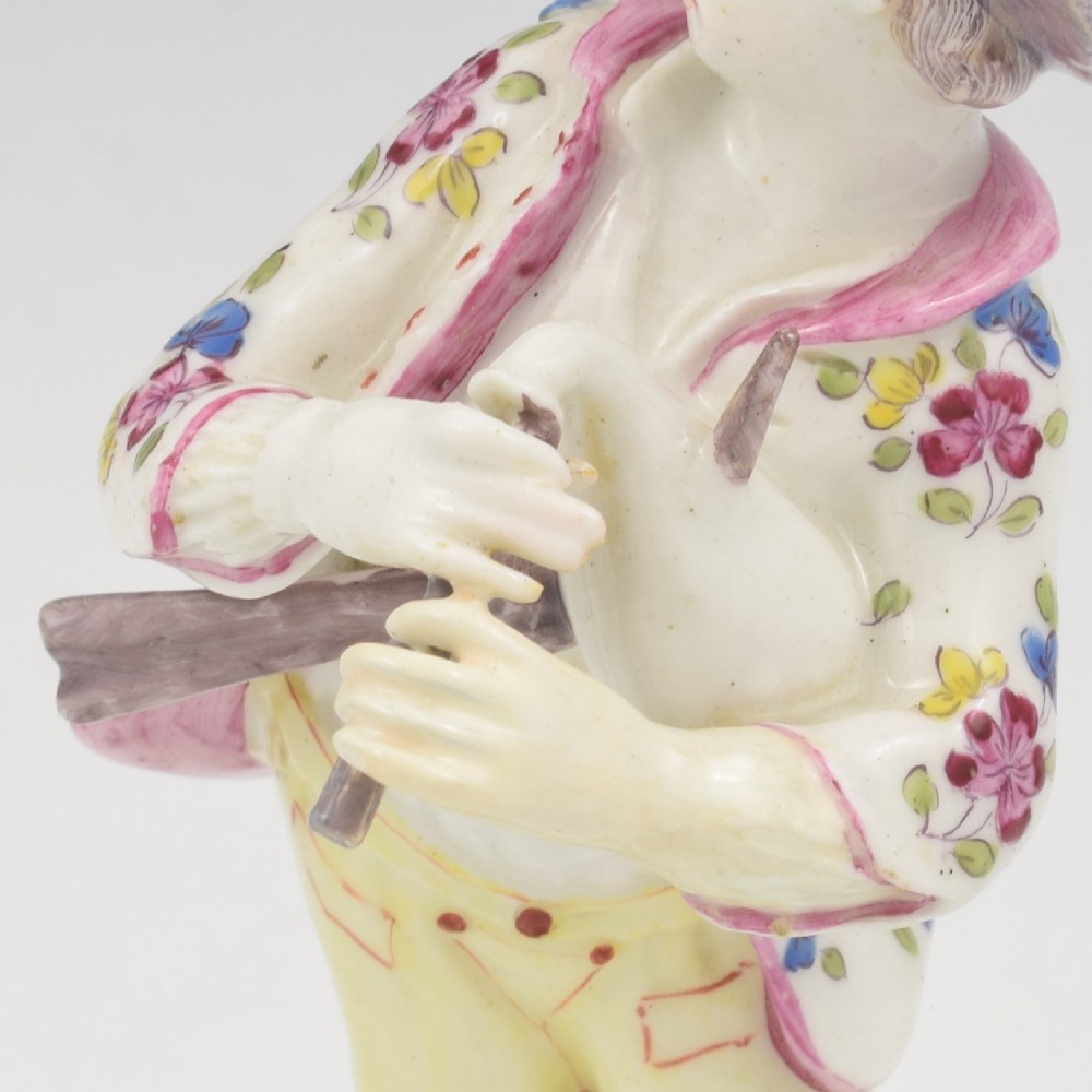 An eighteenth-century Bow porcelain figurine depicting a young shepherd playing a pipe alongside a small dog on a sculpted base. View XIV