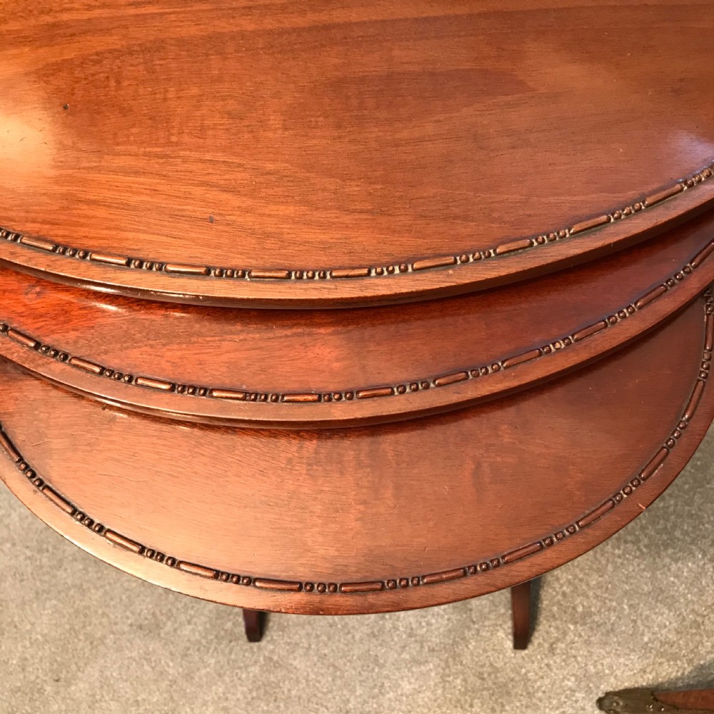 A set of three graduating oval mahogany side tables with carved beaded rims and slender turned legs. View VI