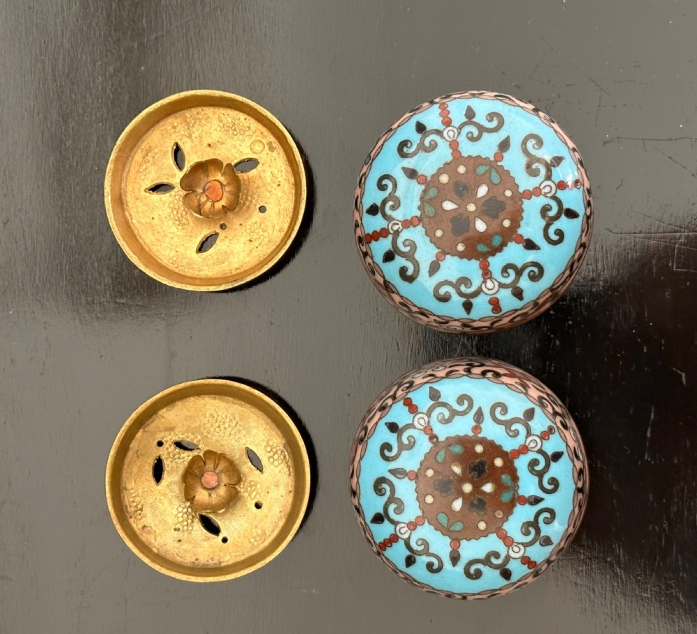A pair of lidded antique cloisonne enamel jars decorated with birds, floral peonies, and intricate geometric patterns on a sky blue ground. View IX
