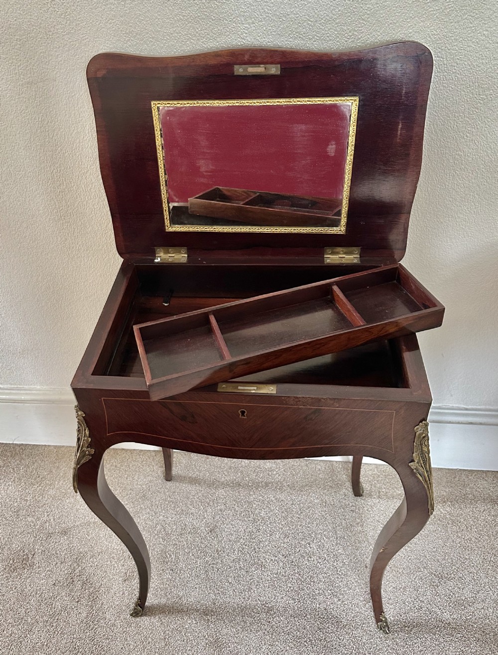 A Victorian Louis XV style dark brown marquetry work table featuring floral wood inlays, brass corner mounts, and curved cabriole legs. View VI