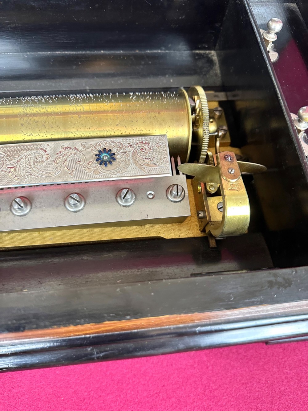 A rectangular Victorian wooden music box featuring floral iris marquetry inlaid on the lid with ebonised moulded borders. View VIII
