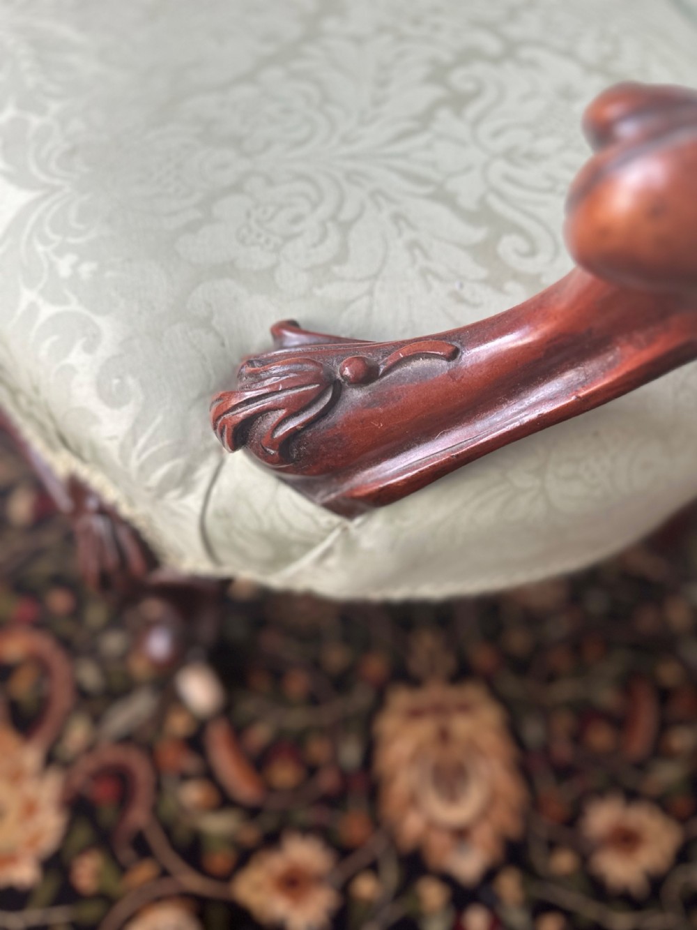 A pair of late Victorian carved mahogany salon armchairs upholstered in light green damask fabric featuring cabriole legs and scroll arms. View VIII