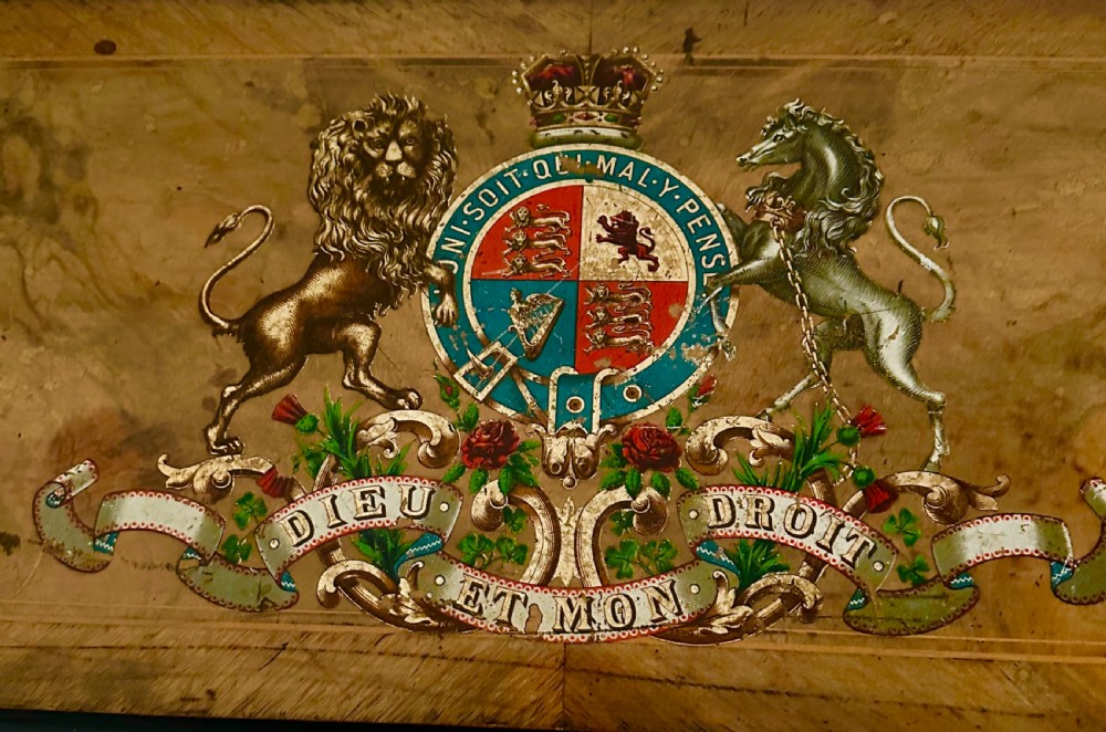 A Victorian burr walnut music box decorated with a painted British royal coat of arms on the top lid and front panel. View IV