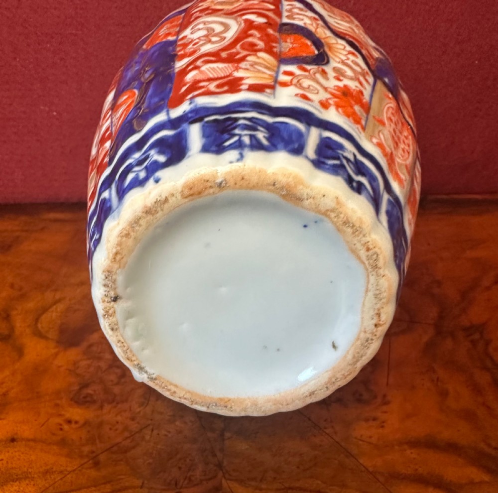 A fluted Japanese Imari porcelain vase featuring hand-painted floral panels in cobalt blue, rust red, and gilt detailing. View VII