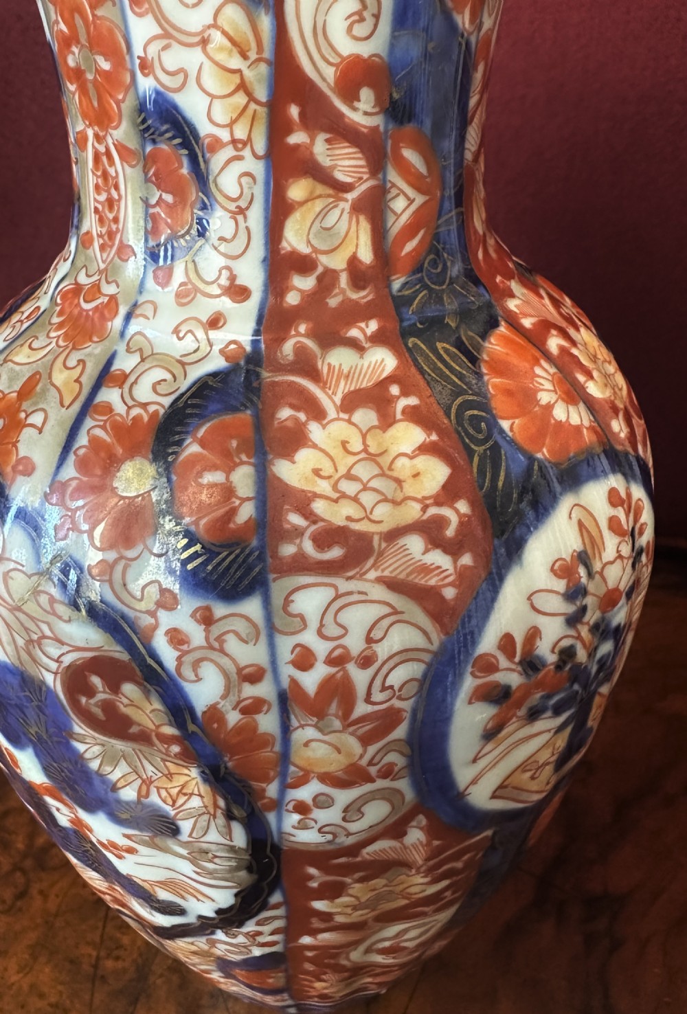 A fluted Japanese Imari porcelain vase featuring hand-painted floral panels in cobalt blue, rust red, and gilt detailing. View VIII