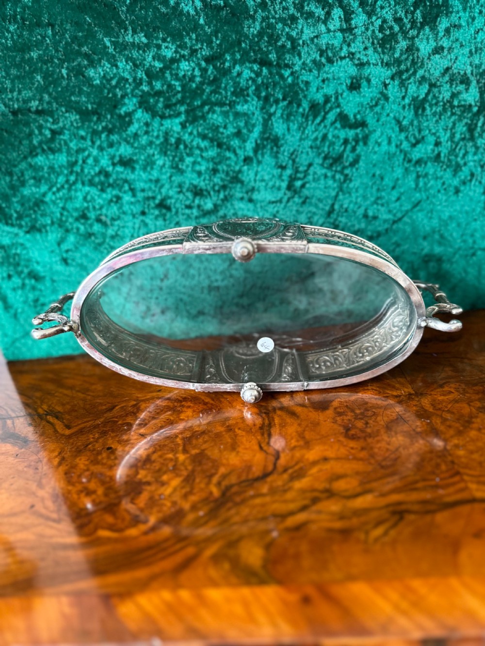 An oblong silver-plated Art Nouveau centrepiece bowl featuring ornate twin handles, relief scrollwork, a central cartouche, and a clear glass liner. View IV