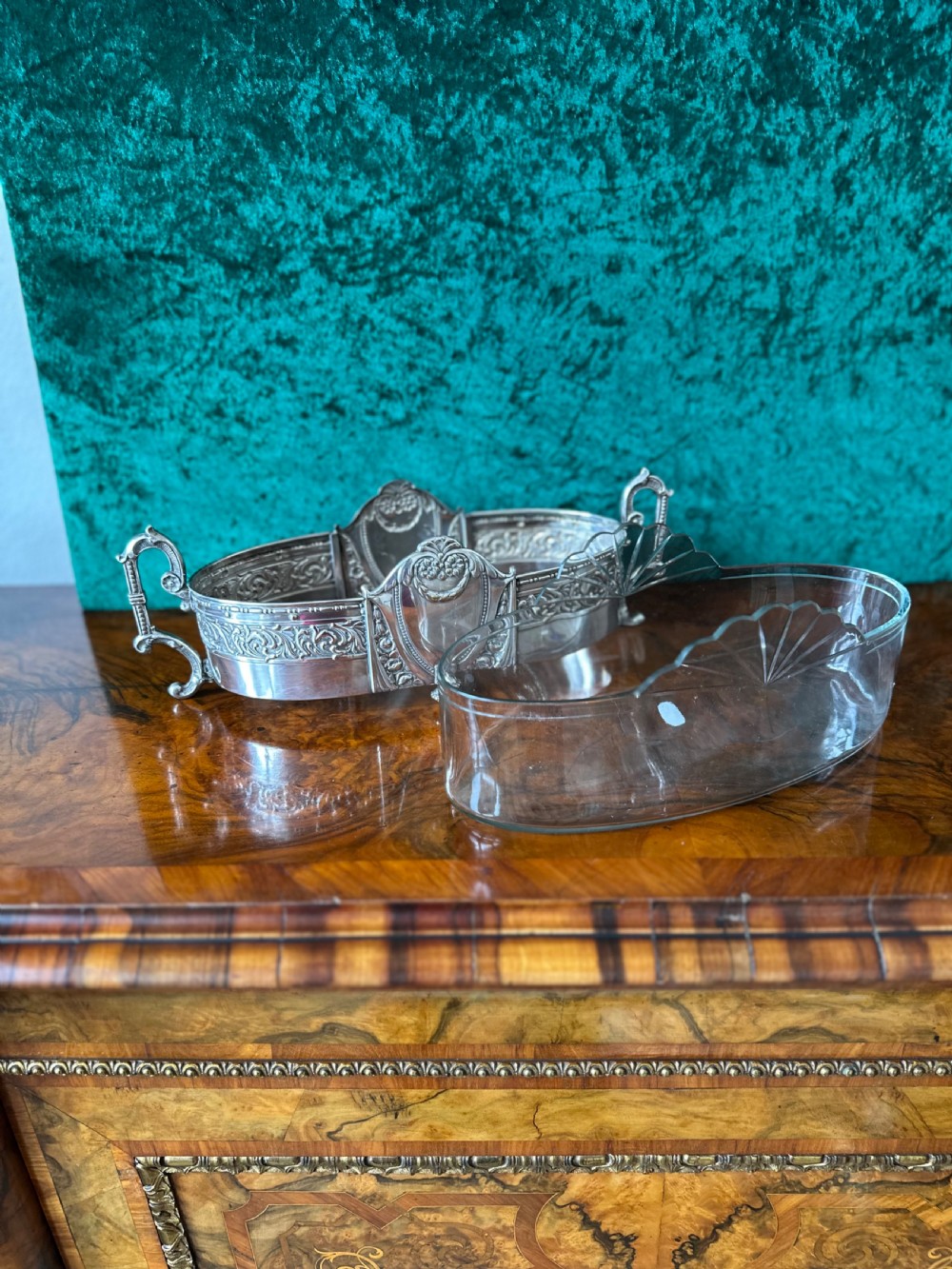 An oblong silver-plated Art Nouveau centrepiece bowl featuring ornate twin handles, relief scrollwork, a central cartouche, and a clear glass liner. View VI