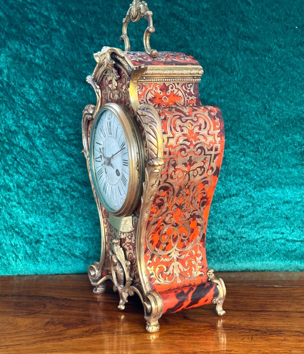 A 19th-century French Louis XV style Boulle mantel clock featuring red tortoiseshell and brass marquetry inlay with gilt bronze mounts. View VII