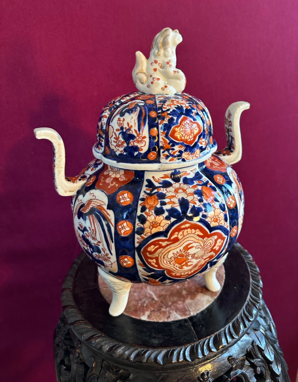 A Japanese Imari porcelain koro incense burner featuring a pierced domed lid topped with a shishi lion finial, twin side handles, tripod feet, and hand-painted blue and iron-red panels. View VII