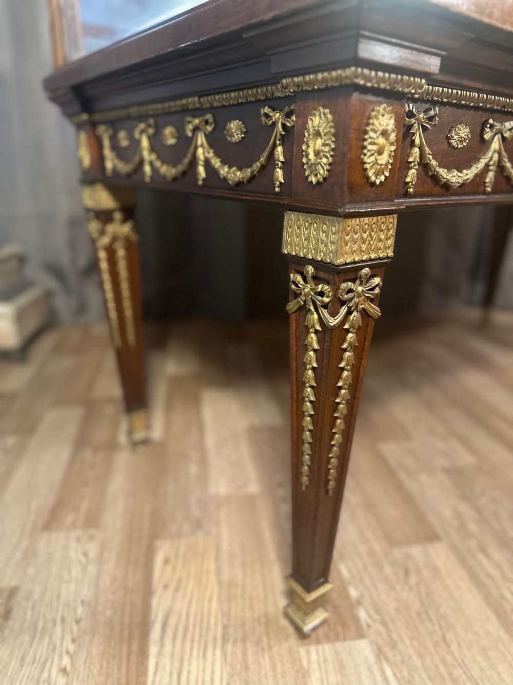 A late 19th-century mahogany table vitrine featuring clear glass panels, a red velvet interior base, tapered legs, and decorative gilt-bronze mounts. View IV