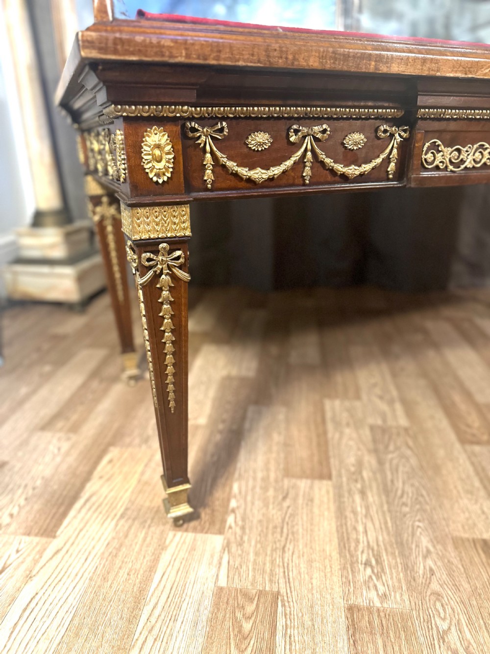 A late 19th-century mahogany table vitrine featuring clear glass panels, a red velvet interior base, tapered legs, and decorative gilt-bronze mounts. View V