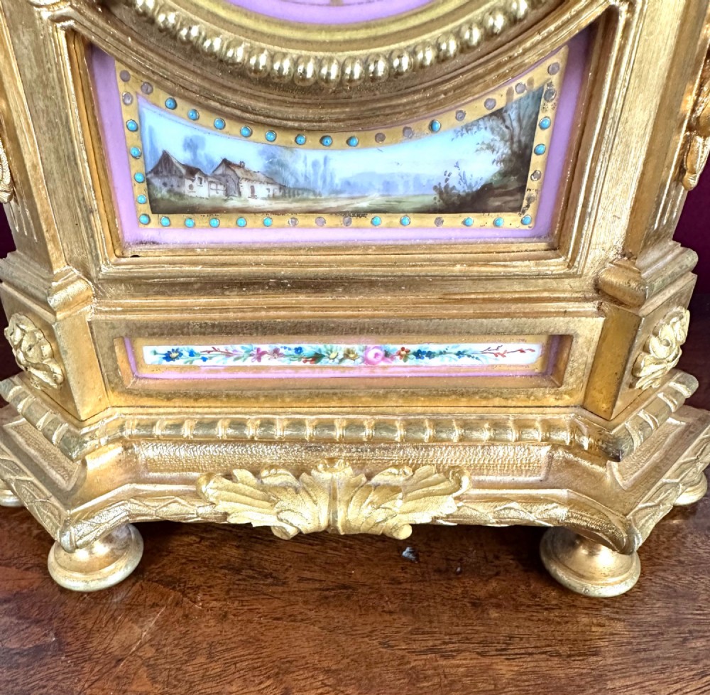 A late 19th-century French gilt bronze mantel clock featuring pink hand-painted porcelain panels and an urn finial. View III