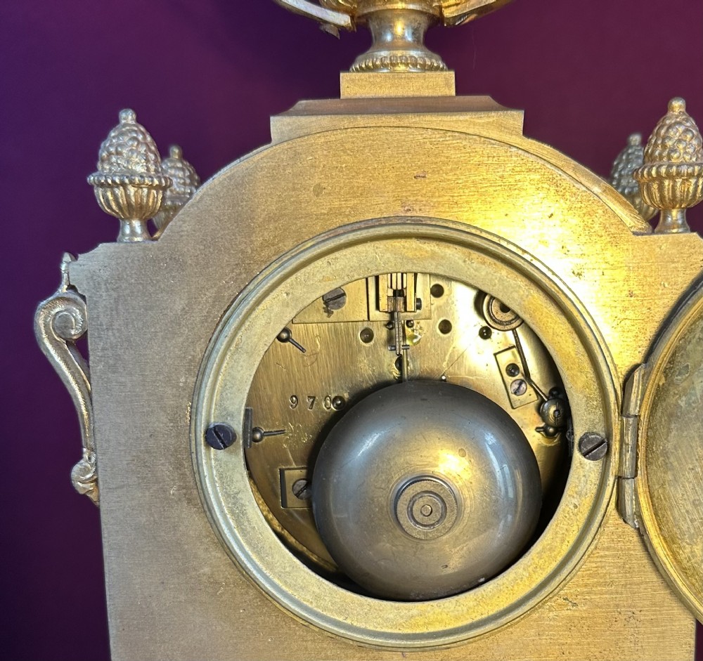 A late 19th-century French gilt bronze mantel clock featuring pink hand-painted porcelain panels and an urn finial. View VII