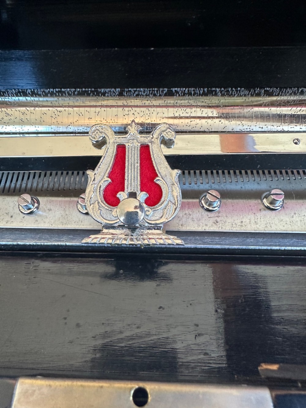 A late nineteenth-century Victorian walnut cylinder music box with an open hinged lid displaying an illustrated tune sheet and an internal brass mechanism behind a glass cover. View IV