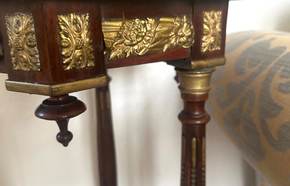 A late nineteenth-century Victorian plant stand featuring turned fluted legs, brass mounts, a pierced gallery, and a marble inset top. View VII