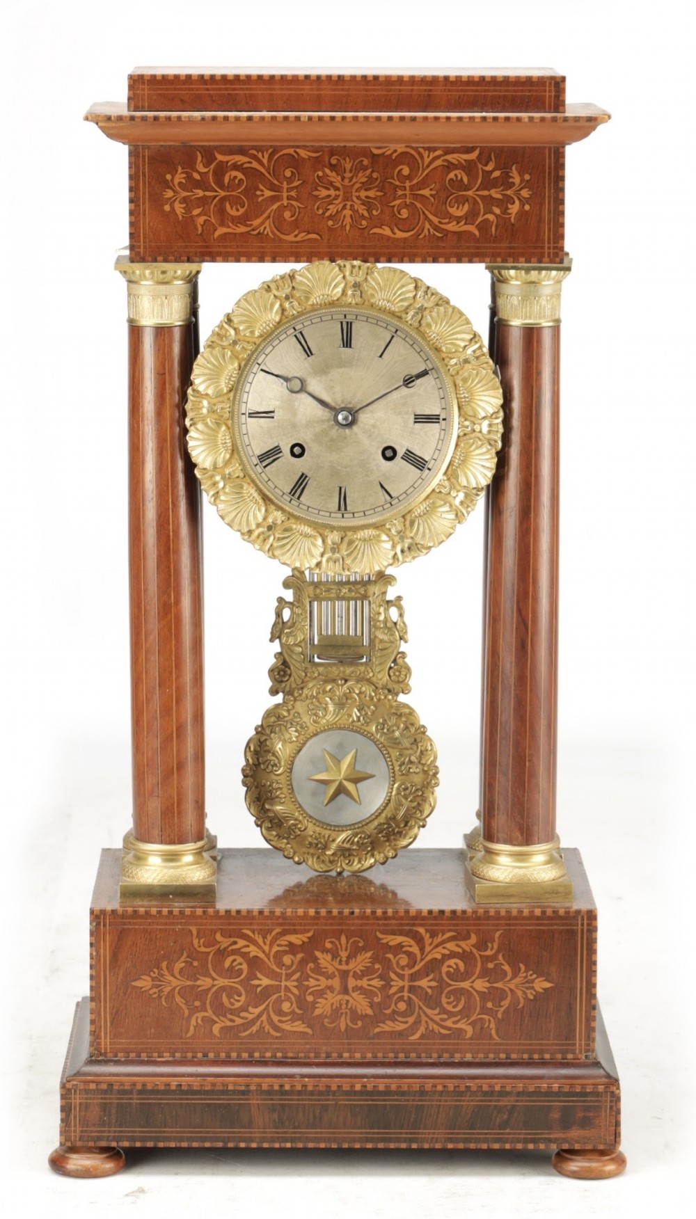 A late 19th-century French portico mantel clock crafted from dark wood with floral marquetry inlays, featuring twin columns and a decorative brass pendulum.