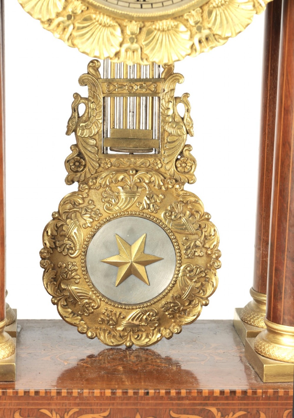 A late 19th-century French portico mantel clock crafted from dark wood with floral marquetry inlays, featuring twin columns and a decorative brass pendulum. View IV