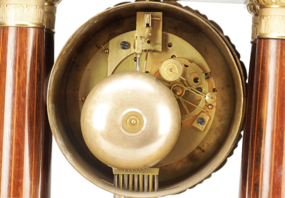 A late 19th-century French portico mantel clock crafted from dark wood with floral marquetry inlays, featuring twin columns and a decorative brass pendulum. View VII