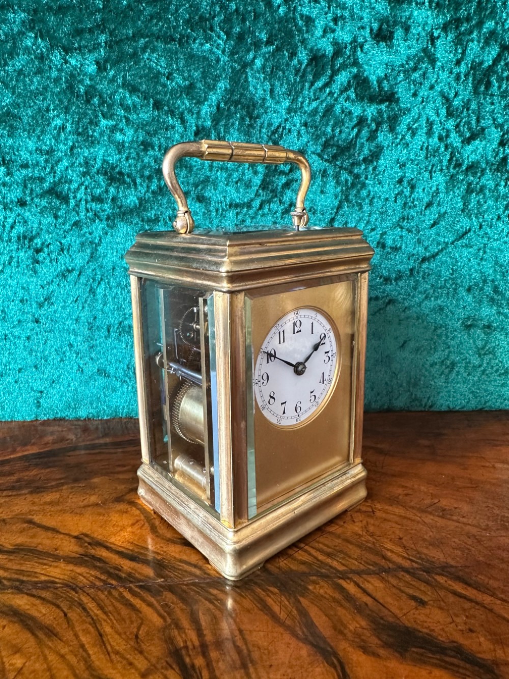 A 19th-century brass repeating carriage clock featuring bevelled glass panels, a top carrying handle, and an enamel dial with Arabic numerals. View III