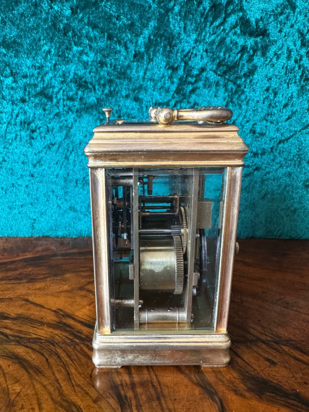 A 19th-century brass repeating carriage clock featuring bevelled glass panels, a top carrying handle, and an enamel dial with Arabic numerals. View IV