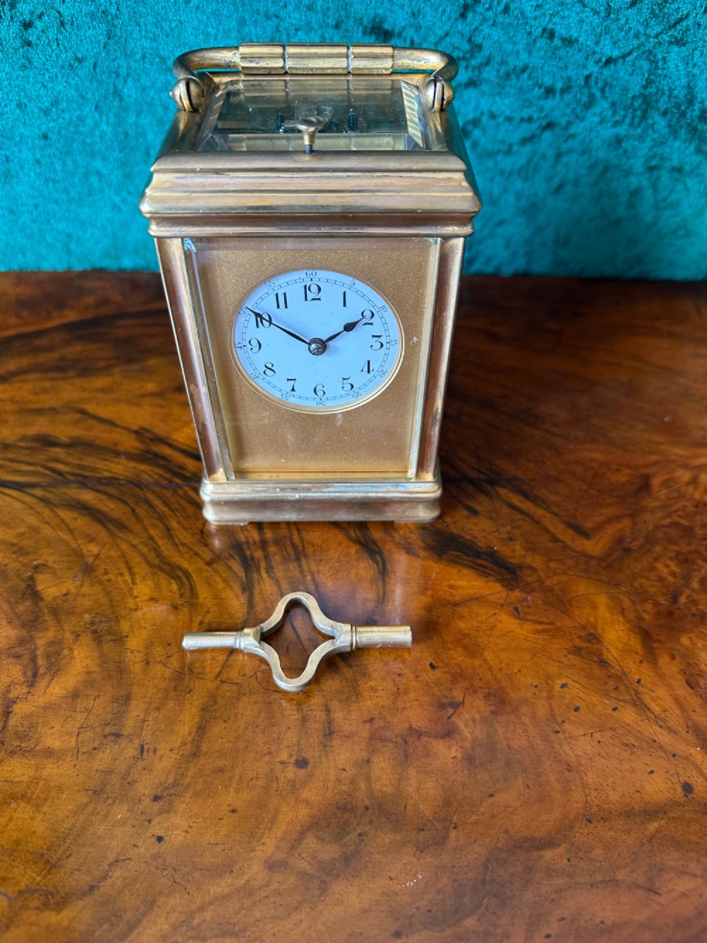 A 19th-century brass repeating carriage clock featuring bevelled glass panels, a top carrying handle, and an enamel dial with Arabic numerals. View VII