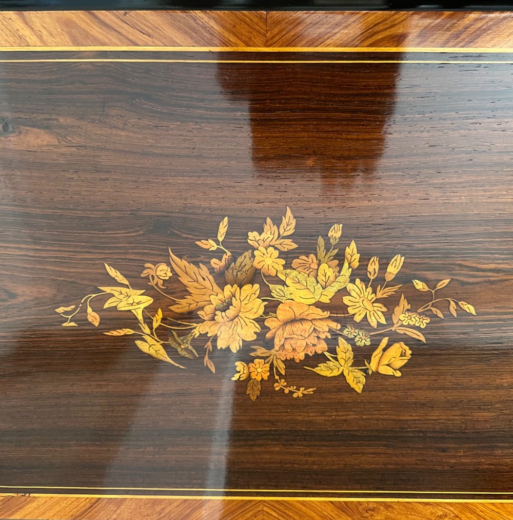 An open Victorian cylinder music box housed in a dark veneered wooden case featuring six exposed bells and an illustrated tune sheet inside the lid. View VIII