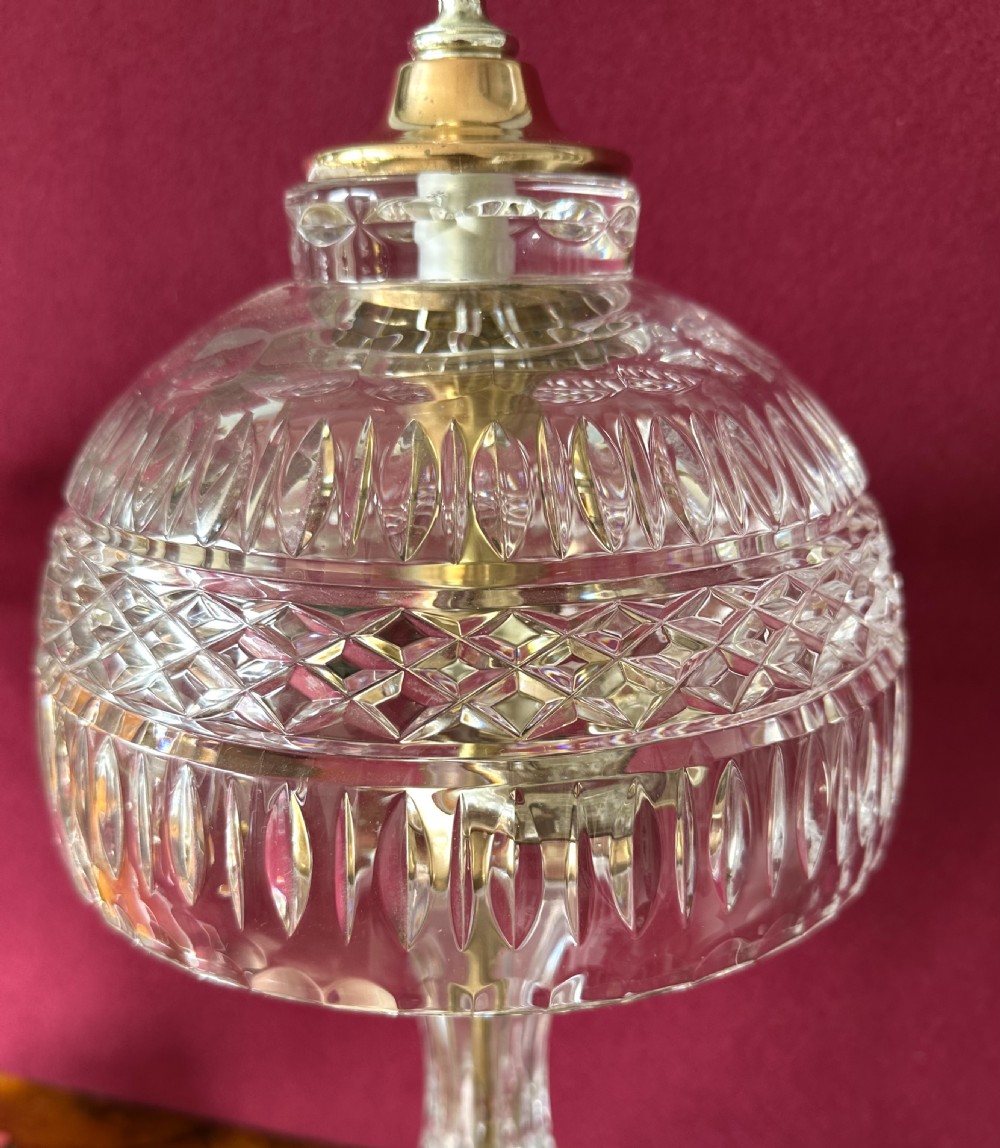 A pair of matching cut crystal table lamps featuring dome shades, faceted baluster stems, square metal bases, and pointed finials. View II