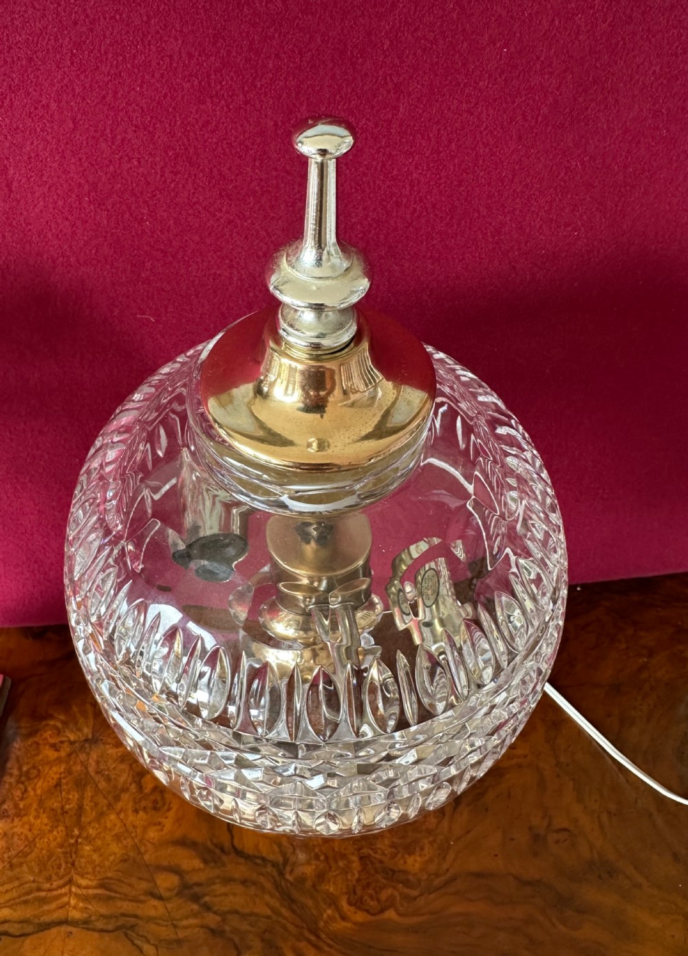 A pair of matching cut crystal table lamps featuring dome shades, faceted baluster stems, square metal bases, and pointed finials. View IV