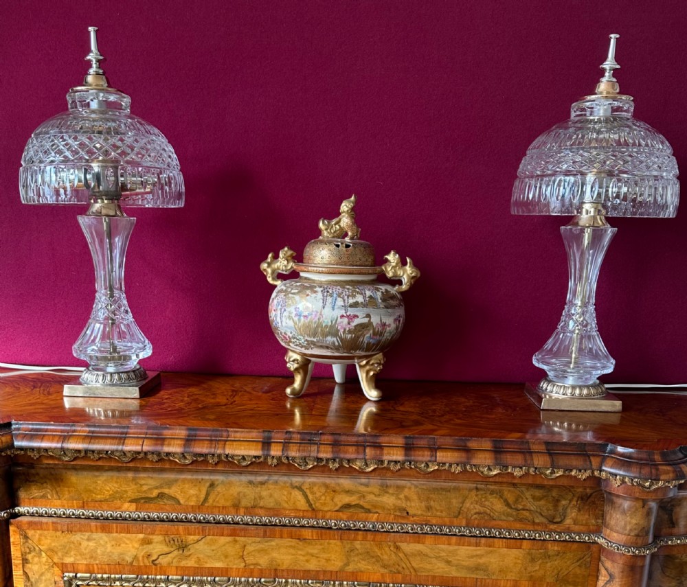 A pair of matching cut crystal table lamps featuring dome shades, faceted baluster stems, square metal bases, and pointed finials. View V