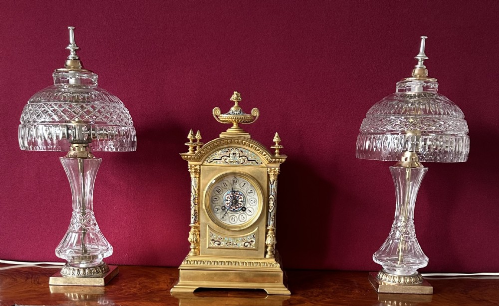 A pair of matching cut crystal table lamps featuring dome shades, faceted baluster stems, square metal bases, and pointed finials. View VI