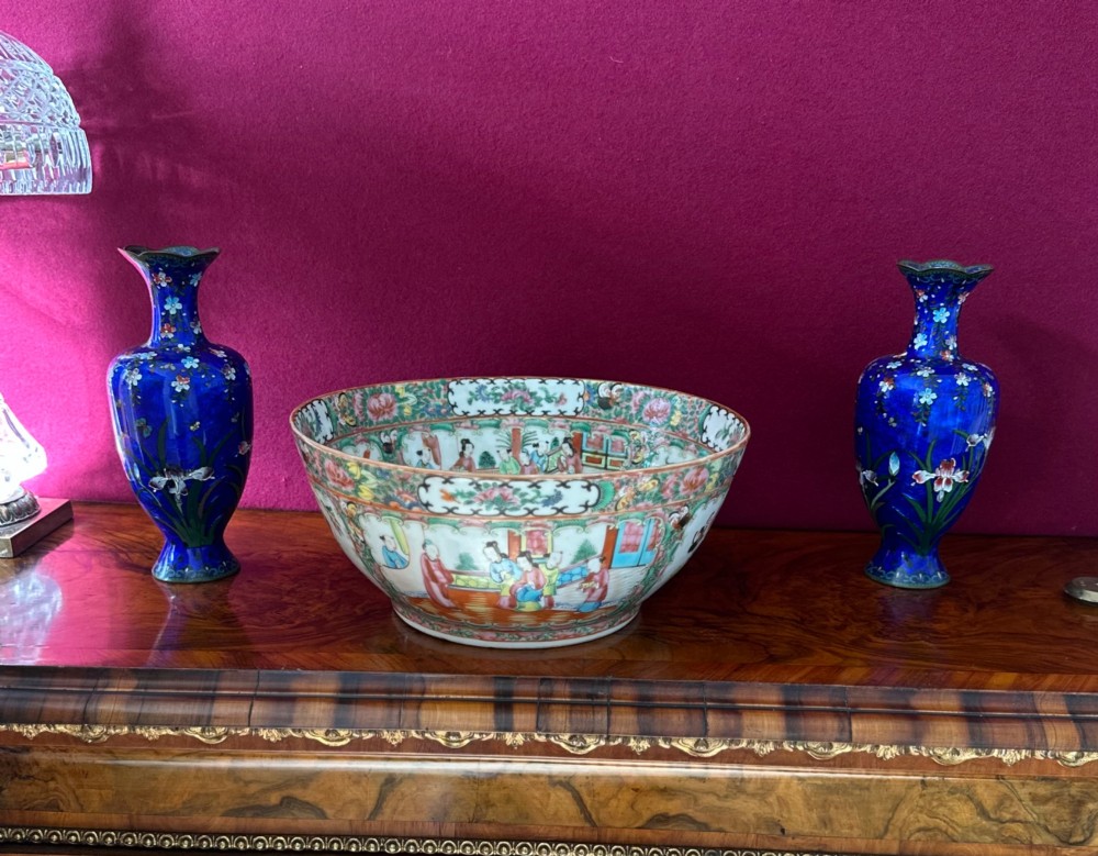 A circular Chinese export porcelain bowl featuring hand-painted panels with human figures in courtly attire framed by floral borders. View VIII