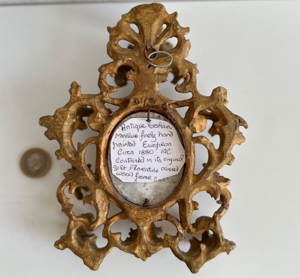 A late 19th-century oval miniature portrait of a woman set within an elaborate gilt metal frame featuring acanthus scrollwork and pierced details. View II