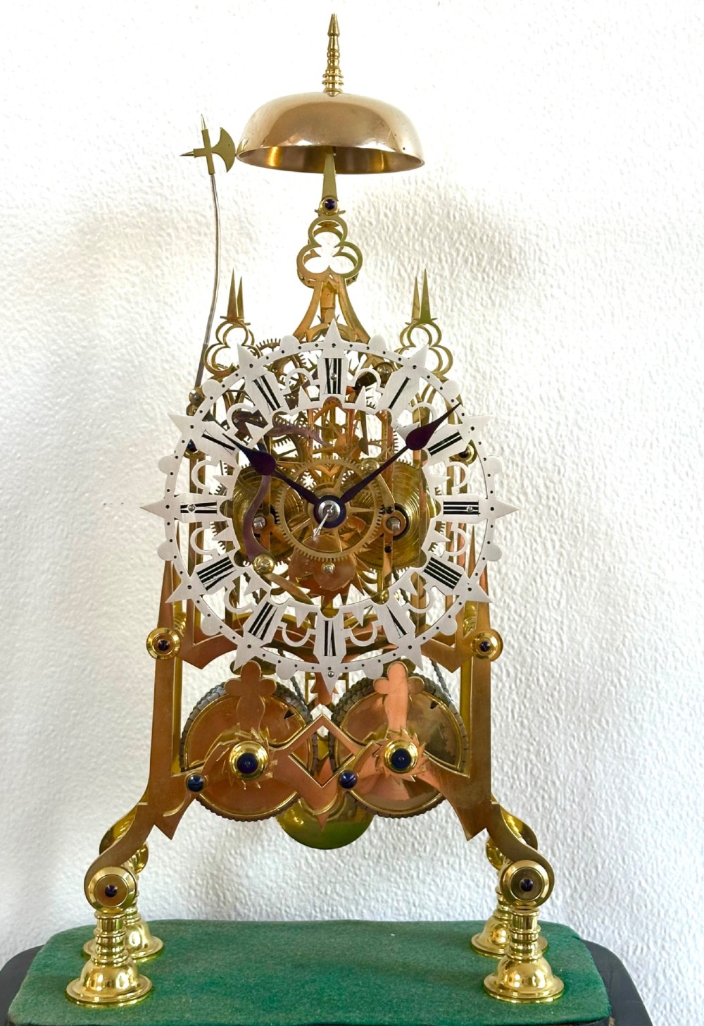A Victorian brass double fusee skeleton clock displaying exposed internal gearing, a gothic pierced frame, a silvered chapter ring, and a top-mounted bell. View II