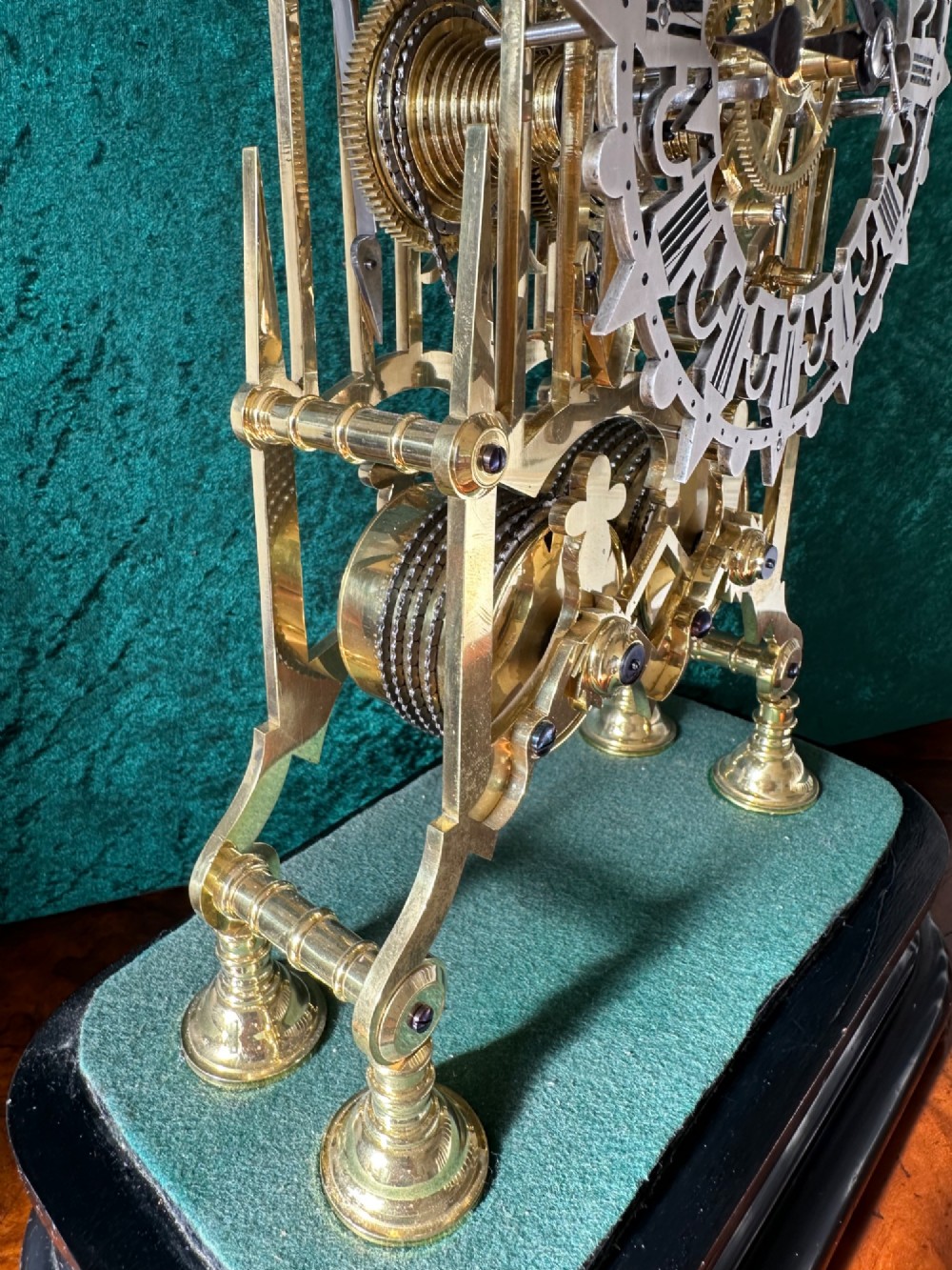 A Victorian brass double fusee skeleton clock displaying exposed internal gearing, a gothic pierced frame, a silvered chapter ring, and a top-mounted bell. View VIII