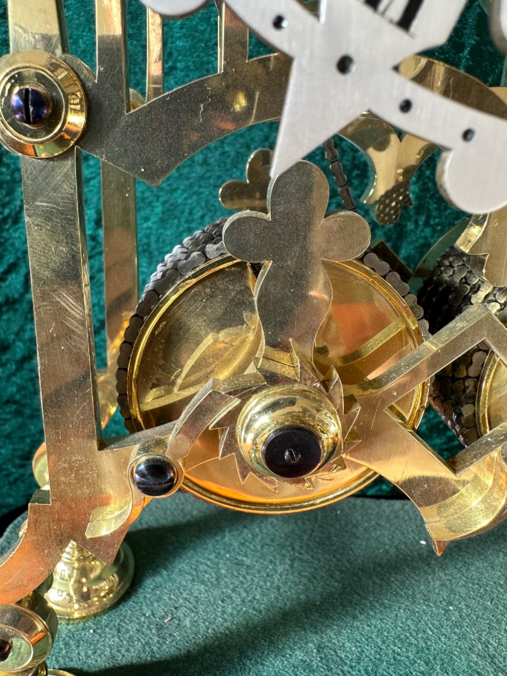 A Victorian brass double fusee skeleton clock displaying exposed internal gearing, a gothic pierced frame, a silvered chapter ring, and a top-mounted bell. View XI
