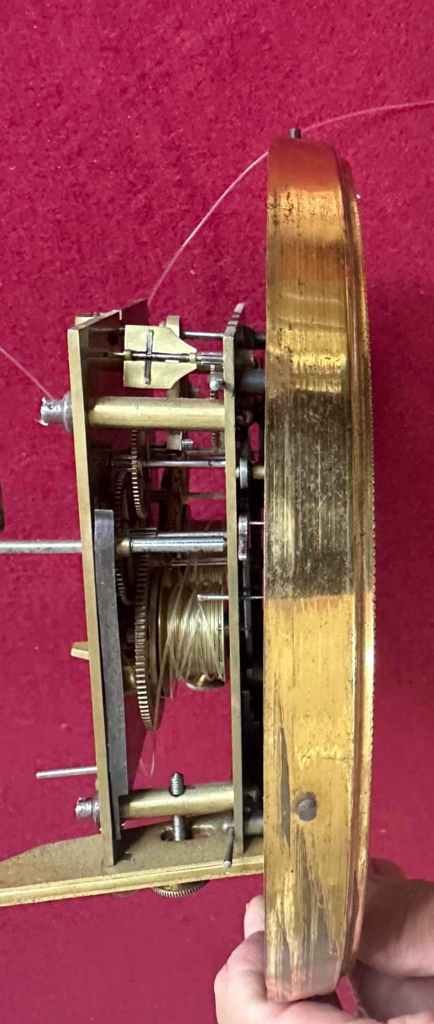 Late 19th-century Victorian walnut wall clock with ebonised columns, top cresting with a carved head motif, two brass weights, pendulum, and a white enamelled Roman numeral dial. View IX