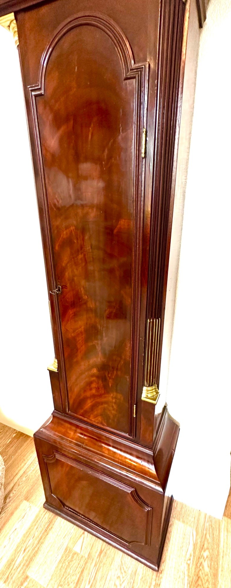 A tall Georgian mahogany longcase clock featuring brass eagle finials, a swan-neck pediment, fluted columns, and an engraved brass dial. View III
