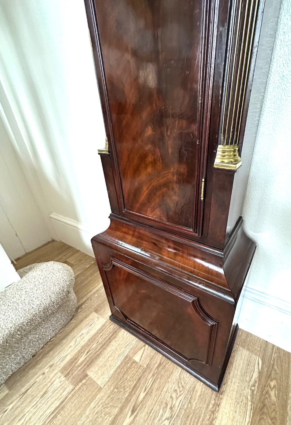 A tall Georgian mahogany longcase clock featuring brass eagle finials, a swan-neck pediment, fluted columns, and an engraved brass dial. View IV