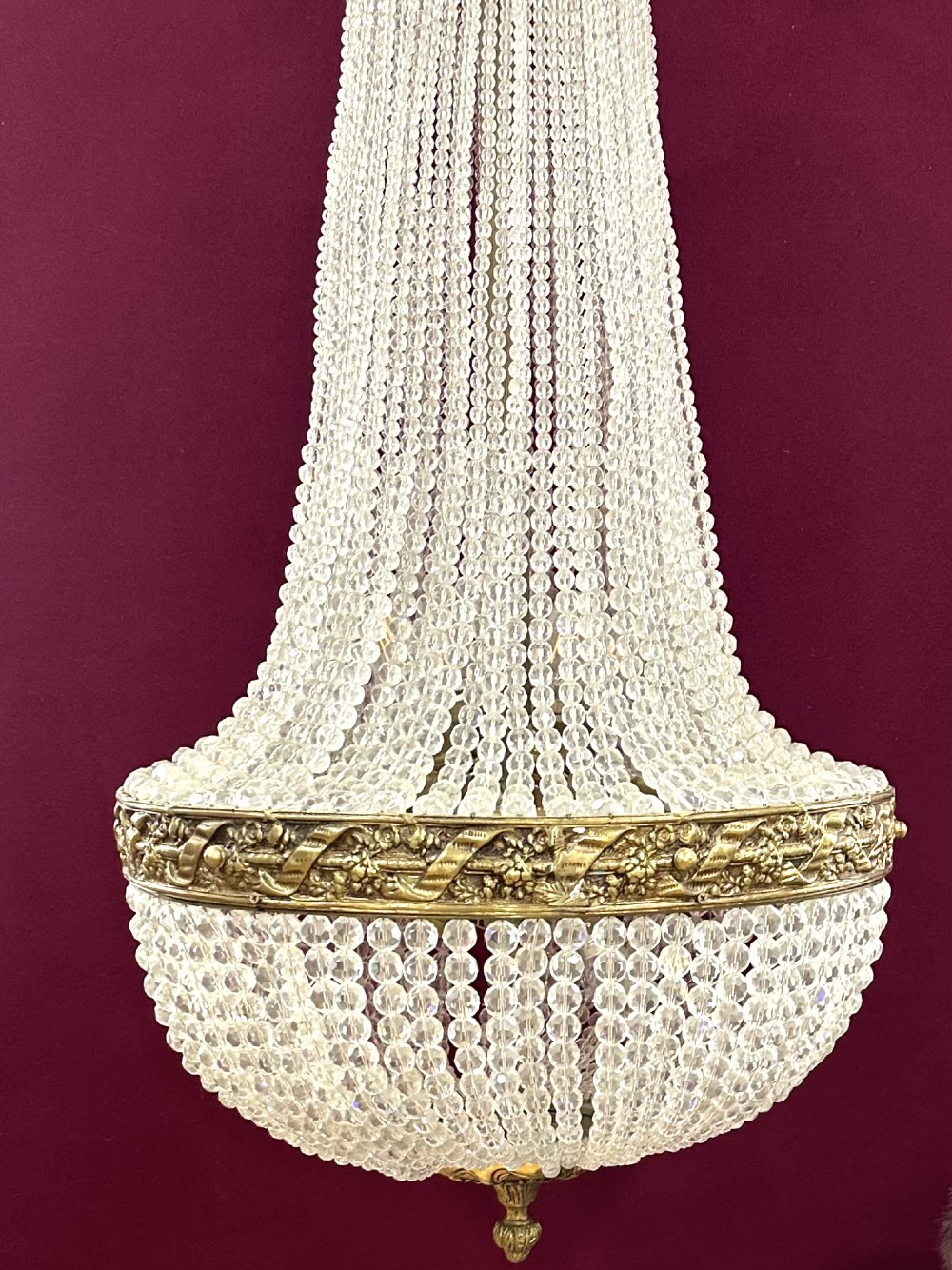 A French Empire style crystal basket chandelier featuring cascading glass bead strands and a chased gilt-bronze ornamental ring. View III